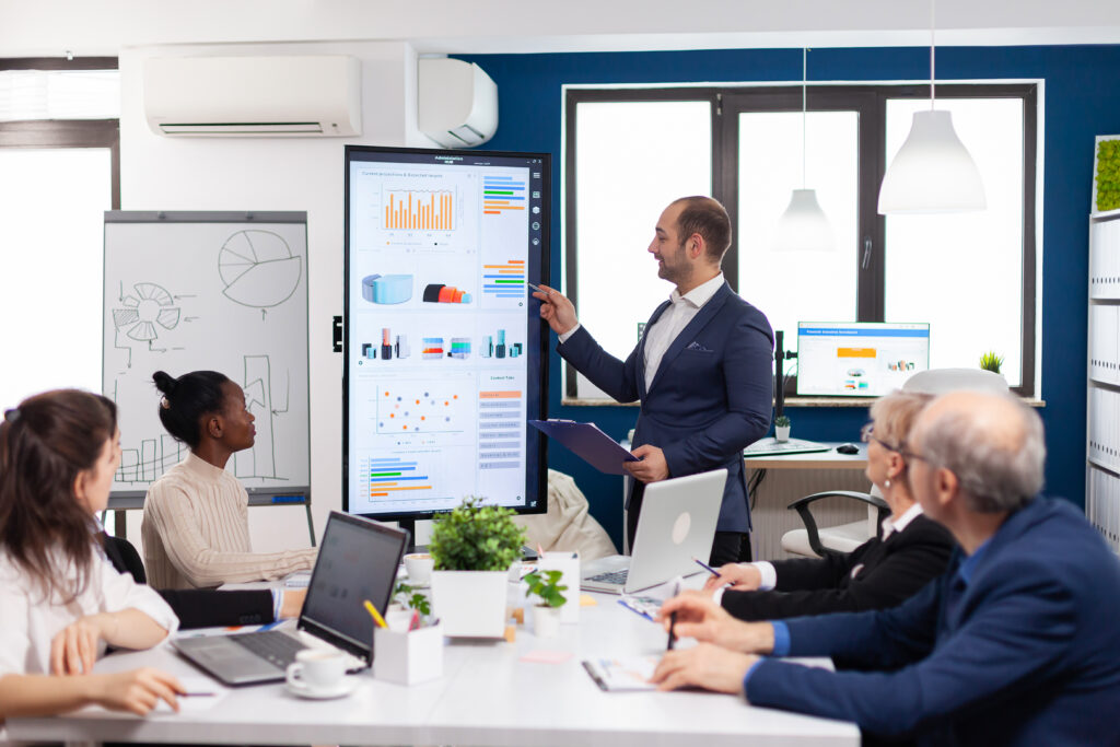 Business partner presenting company strategy to diverse team